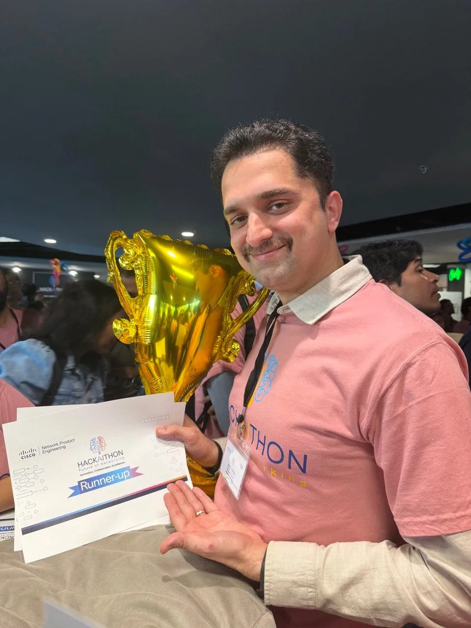 Mike Ketabforoosh holding a runner-up certificate and trophy at a Cisco hackathon